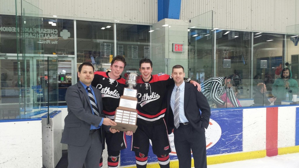  CUA Ice Hockey poses with their championship trophy Photo Credit: Charles Hostovsky  