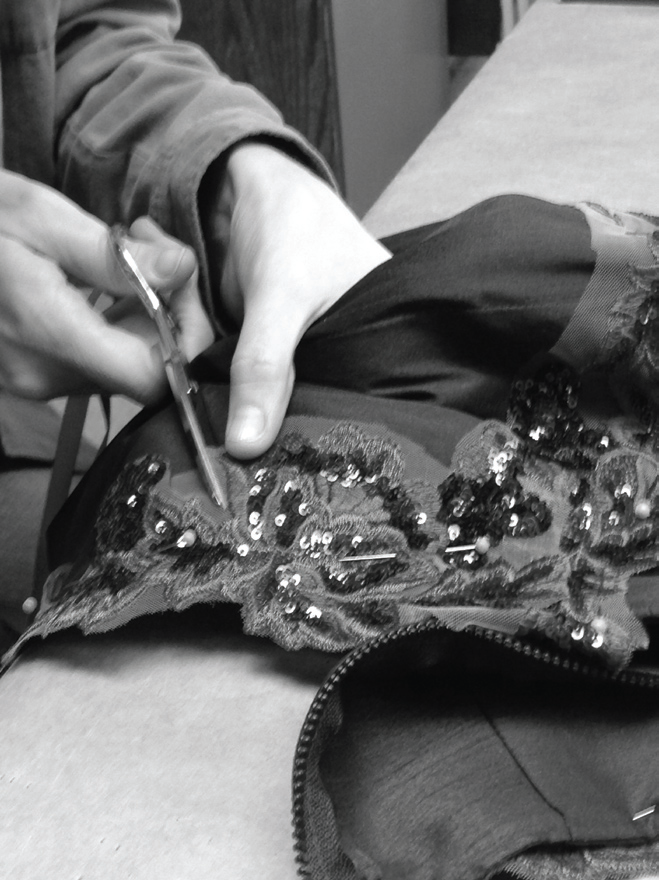Julia Cray works on one of the costumes. 