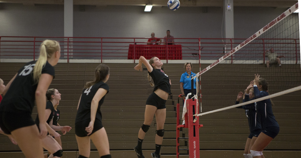 Senior middle hitter Kathryn Herrington rises up for a kill against Washington College. Courtesy of CUACardinals.com