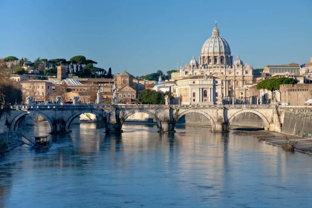 A picture of St. Peters Basilica viewed from the Tiber River