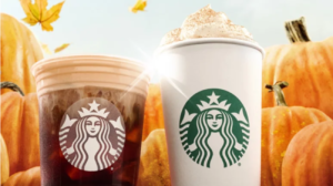 Two Starbucks drinks in front of pumpkins